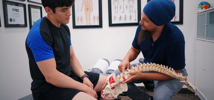 Why Your Back Pain Keeps Coming Back A doctor explains spinal issues to a patient using a spine model during a medical consultation, chiropractor mandurah